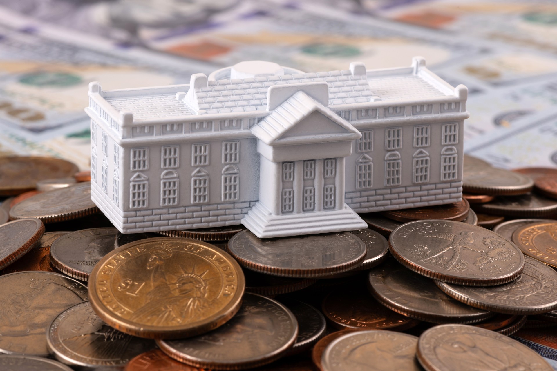 Miniature symbolic residence of the US President - White House and American coins and bills