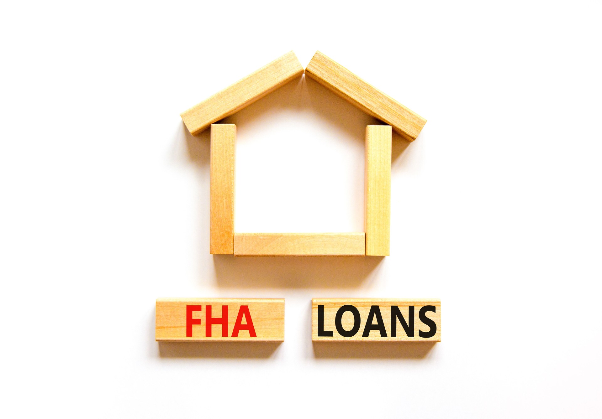 FHA federal housing administration loans symbol. Concept words 'FHA federal housing administration loans' on wooden blocks on a beautiful white background. Business and FHA loans concept. Copy space.